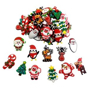 Macro detail of various PVC Christmas charms including Santa, Reindeer and Tree for DIY gifts