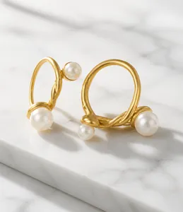 Detail of a gold irregular twisted ring featuring multiple white pearl embellishments
