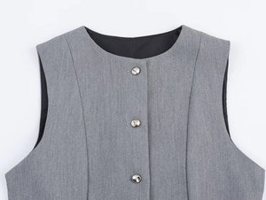Detail view of grey textured crepe vest featuring silver buttons and clean round neckline