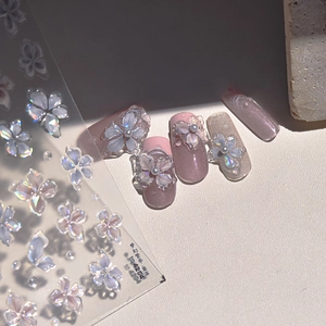 Detailed 3D iridescent translucent flower nail stickers applied on pink press-on nails