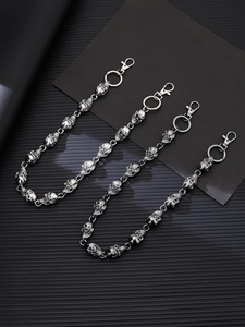 Detailed macro view of gunmetal punk skull waist chains with tiered metal alloys