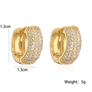Detail shot of 1.3cm gold plated huggie earrings with cubic zirconia and size info