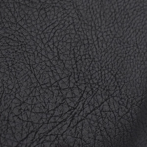 Macro shot of black PU leather texture with detailed lychee grain on a military beret
