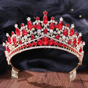 Detailed view of baroque crown hair comb with red teardrop crystals and gold metal finish