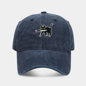 Close-up of cat with knife embroidery on washed denim baseball cap in dark navy
