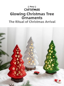 Glow-in-the-dark frosted Christmas trees with gold patterns on wooden bases