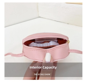 Detailed interior view of a pink mini crossbody bag for kids showing storage space
