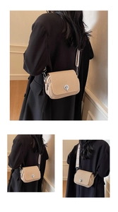 Detail of beige woven crossbody bag featuring silver turn-lock and geometric wide strap