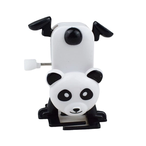 Mechanical wind-up panda toy in handstand pose made of smooth black and white plastic