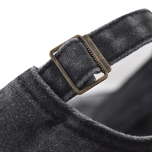 Macro view of vintage bronze buckle and washed cotton texture on baseball cap