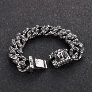 Macro view of vintage tiger head links and secure clasp on heavy stainless steel bracelet