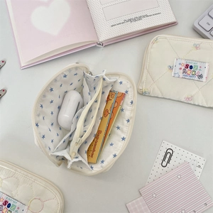 Detailed internal view of quilted cream wallet with card slots and butterfly embroidery