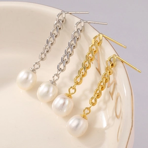 Detailed macro view of S925 silver needles and pearl tassel earrings in gold and silver
