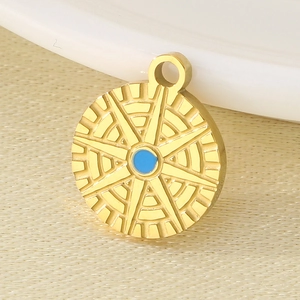 Golden North Star stainless steel pendant with blue stone on beige textured fabric