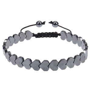 Detail of heart-shaped hematite beads on a black braided adjustable cord bracelet