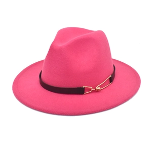 Detail of rose red wool fedora hat featuring black leather band and gold metal buckle