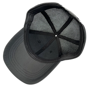 Detail of black mesh trucker hat interior showing sweatband and adjustable snapback closure