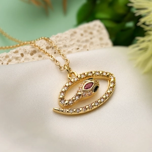 Bohemian gold plated snake necklace with clear zircons and red gemstone eyes on silk