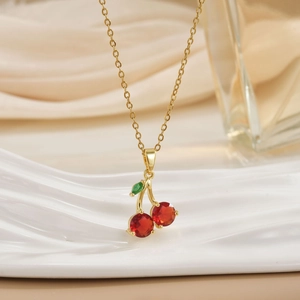 Elegant gold cherry pendant necklace with red cubic zirconia and green leaf detail