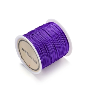 Close-up of dark purple 0.8mm polyester cord roll for DIY jewelry and knotting