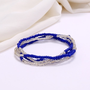 Detail of multilayer blue seed bead beach waist chain with a spiral woven design