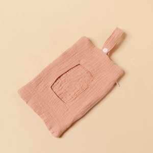 Detailed view of pink cotton muslin baby wipe organizer with hanging snap strap and zipper