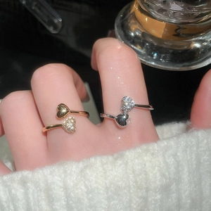 Close-up of dual heart adjustable rings with sparkling zircon pavé and polished finish
