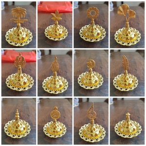 Close-up of 12 luxury gold hollow zinc alloy incense burner lids with varied ornate tops
