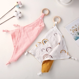 Soft cotton baby comforter set with wooden rings and rainbow pattern in pink and white
