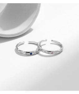 Macro detail of adjustable S925 sterling silver rings with hammered texture and colorful gems