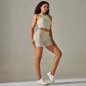 Beige seamless ribbed yoga set featuring high-neck crop top and high-waist biker shorts