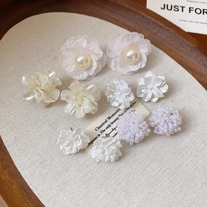 Detail of elegant French vintage floral earrings with pearls and delicate petals