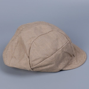 Close-up of the breathable linen texture and stitching on the khaki newsboy cap