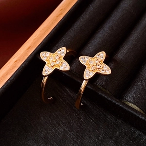 Macro shot of gold-plated C-shaped flower earrings with pavé-set cubic zirconia