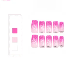 Detailed view of pink gradient press-on nails with 3D flower petals and tiny rhinestones