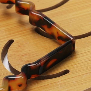 Macro shot of wavy tortoiseshell acetate headband with brown amber texture details