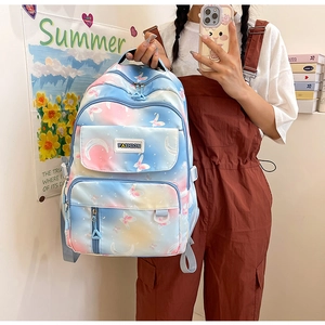 Detail of gradient school backpack with butterfly print and fashion label