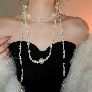 Detailed view of layered white pearl necklace showing multiple sizes and creamy luster