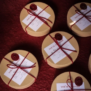 Top view of French style kraft paper wedding favor boxes with red wax seal and card