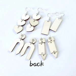Detailed back view of laser-cut wooden earrings set with metal pins and hooks