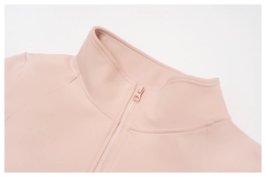 Close-up of stand collar and matching resin zipper on light pink athletic jacket