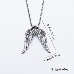 Detail view of silver double wings pendant with feather textures and size measurements
