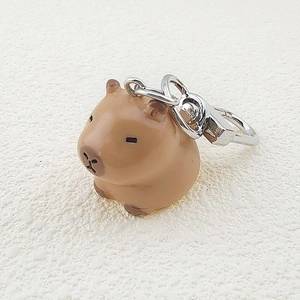 Close-up of a 3D resin Capybara keychain with a silver metal lobster clasp and ring