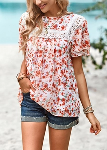 Close-up of white floral chiffon top with lace stitching and ruffle sleeves on beach