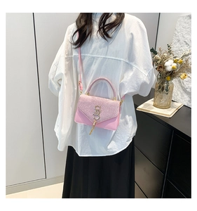 Pink sequin shoulder bag featuring a gold S-shaped buckle and stylish tassel detail