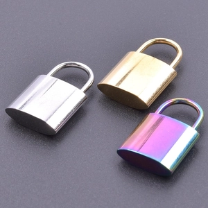 Detailed trio of small stainless steel padlocks in silver, gold, and rainbow finishes
