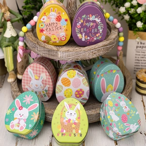 Set of 8 Easter egg-shaped tin boxes with rabbit patterns on a wooden display shelf
