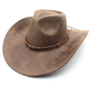 Detail of a brown suede western cowboy hat with a woven texture and vintage metal buckle