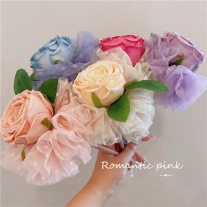 Handheld bouquet of LED rose pens with polka dot lace and colorful artificial petals