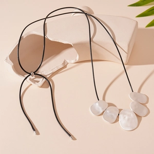 Minimalist adjustable sweater necklace featuring five irregular silver metal pendants on black cord